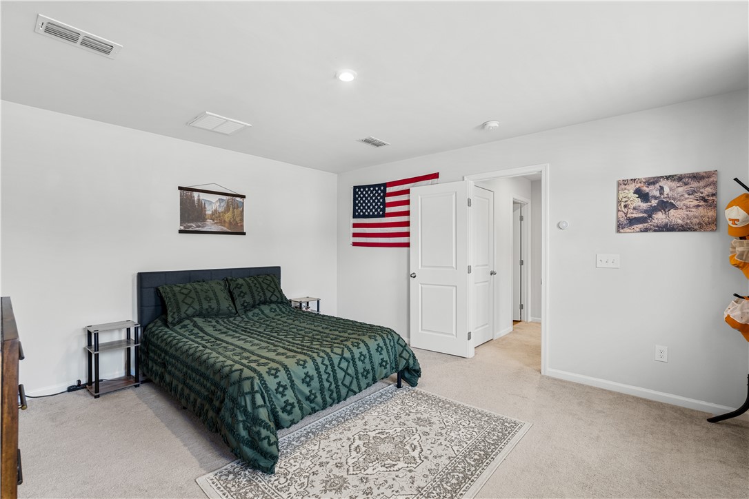 115 Queens Mill Court Pendleton, SC 29670 - Photo 19 of 32 Plush carpeting and neutral-toned walls create a relaxing atmosphere in this comfortable bedroom layout.