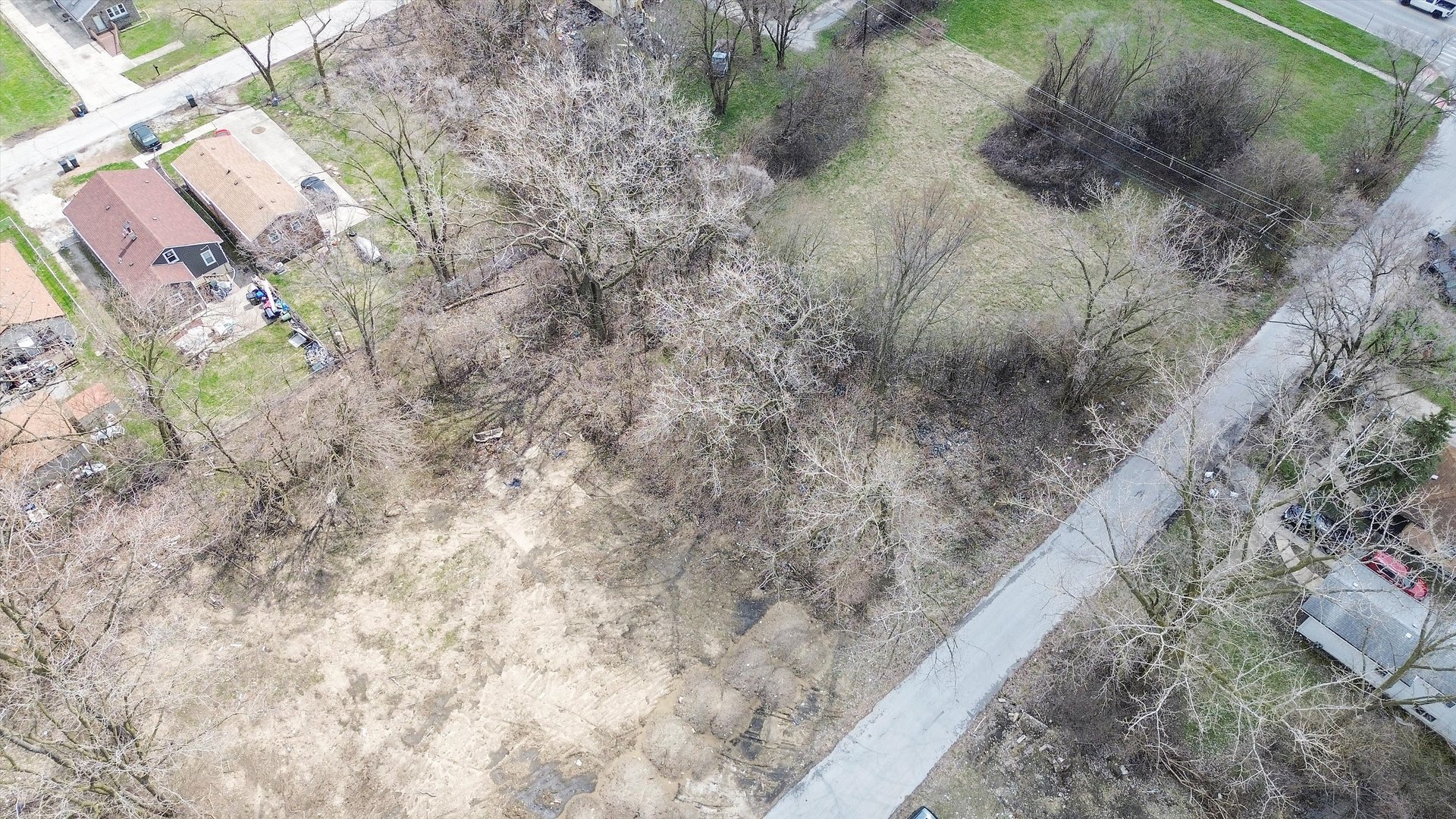 13435 South Lawndale Avenue Robbins, IL 60472 - Photo 6 of 16 a view of a dry yard with wooden fence