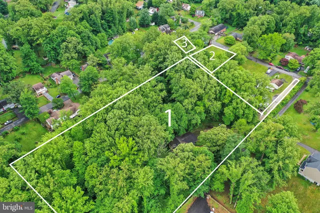 a backyard of a house with lots of green space and trees