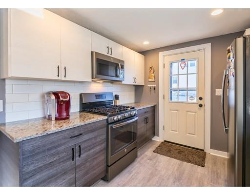 1 Dickie Road Woburn, MA 01801 - Photo 4 of 22 a kitchen with stainless steel appliances granite countertop a refrigerator and a stove top oven
