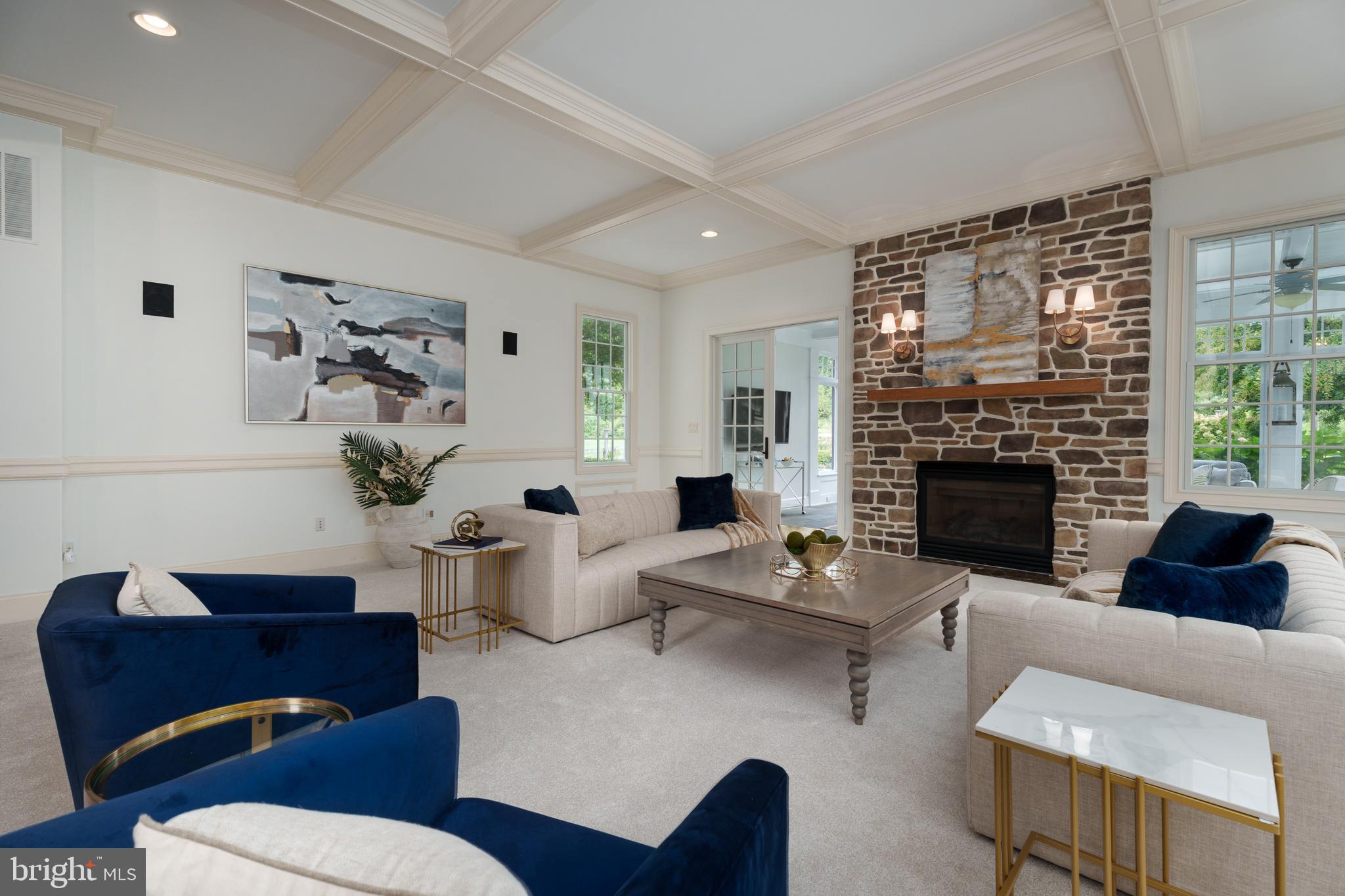 6997 Phillips Mill Road New Hope, PA 18938 - Photo 27 of 85 a living room with furniture potted plant and a fireplace