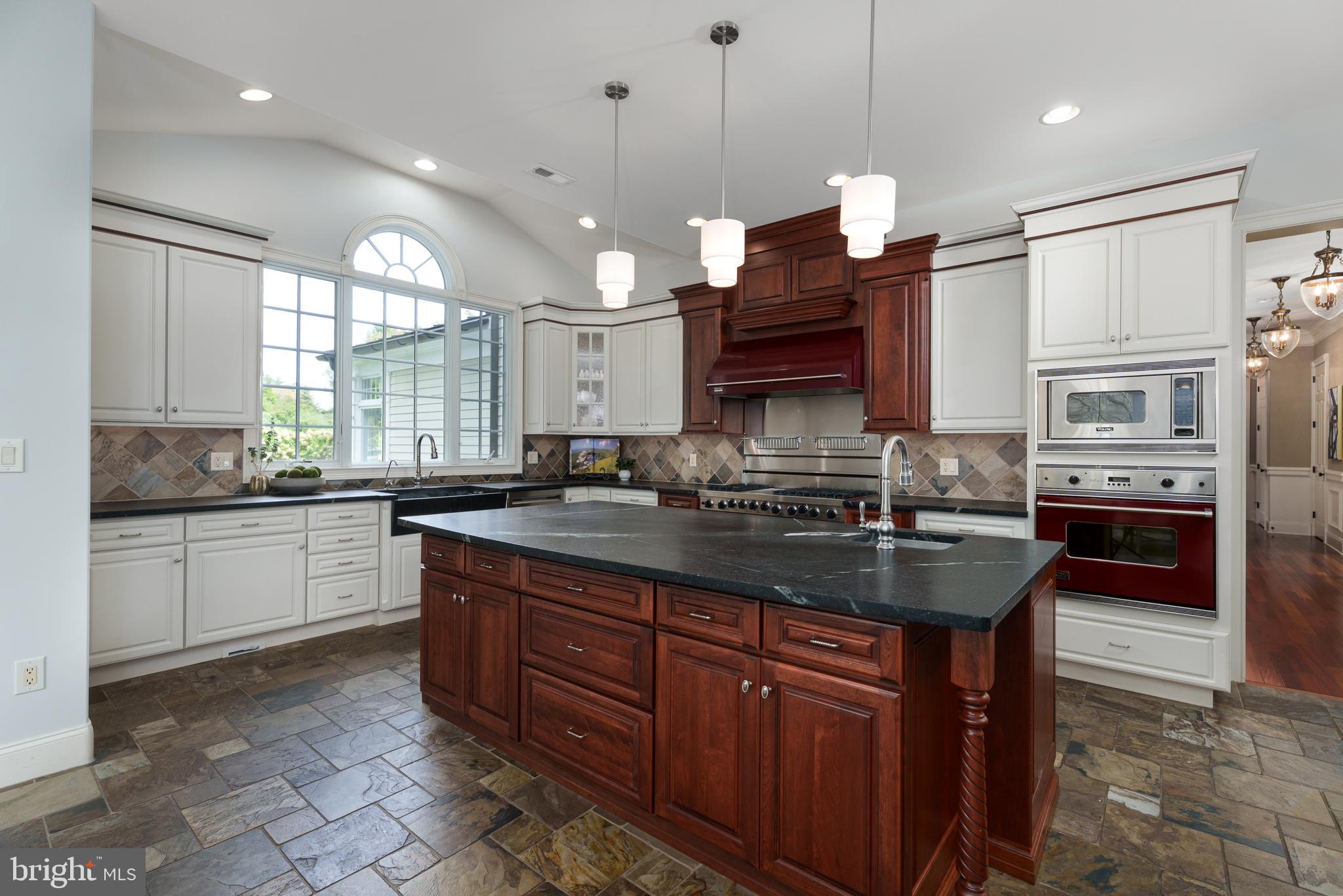 6997 Phillips Mill Road New Hope, PA 18938 - Photo 31 of 85 a kitchen with stainless steel appliances granite countertop a sink a stove and a wooden cabinets