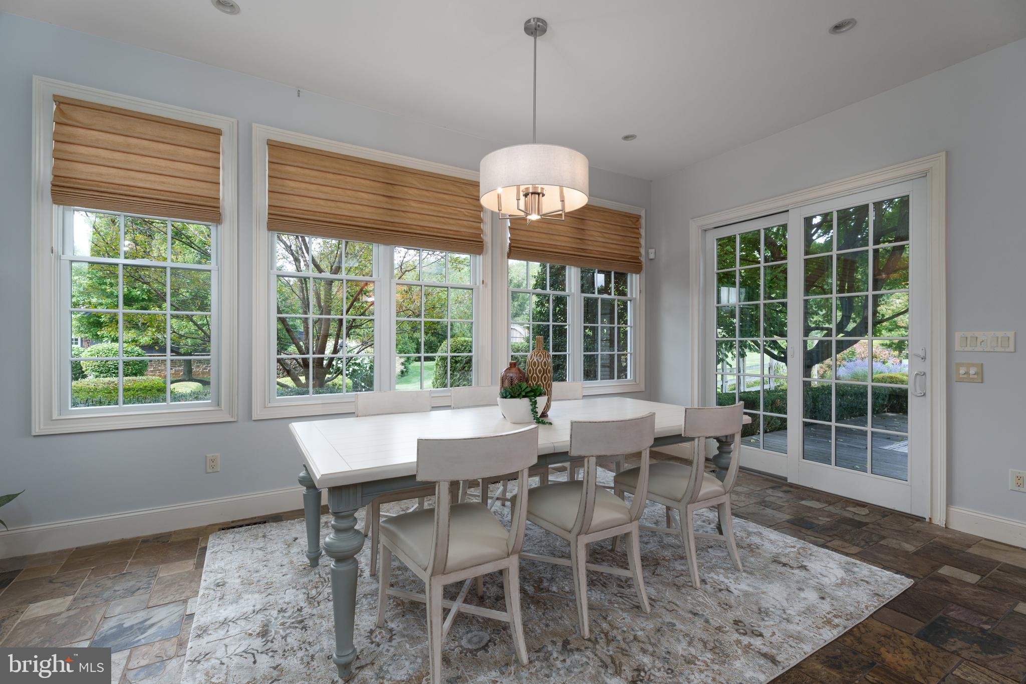 6997 Phillips Mill Road New Hope, PA 18938 - Photo 33 of 85 a dining room with furniture a chandelier and wooden floor