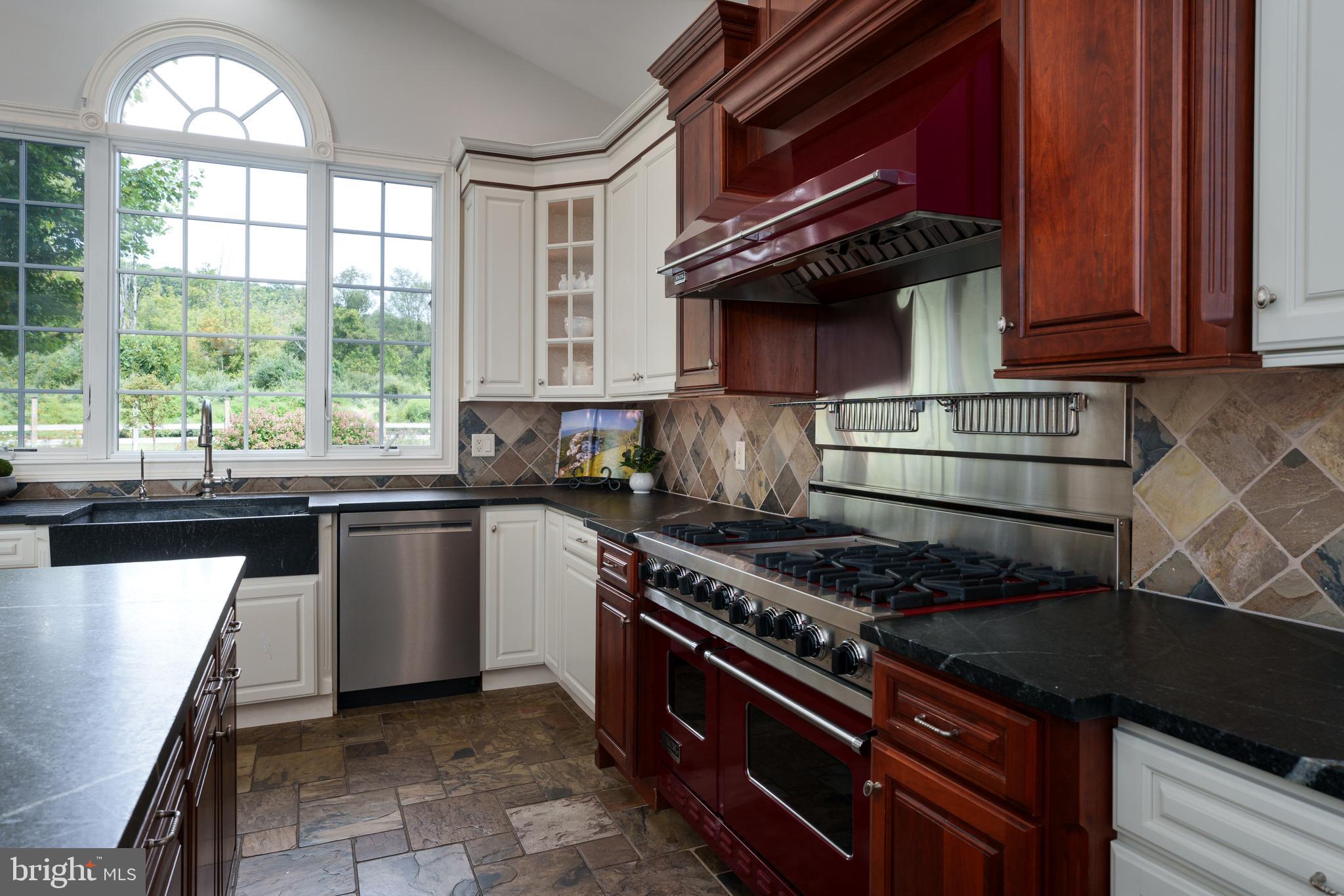 6997 Phillips Mill Road New Hope, PA 18938 - Photo 34 of 85 a kitchen with stainless steel appliances granite countertop a stove a sink and a microwave
