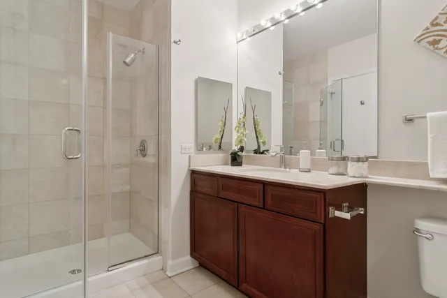 a bathroom with a shower sink and mirror