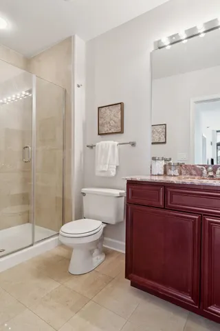 a bathroom with a granite countertop toilet sink and shower