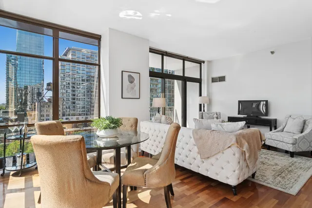 a living room with furniture a large window and a flat screen tv