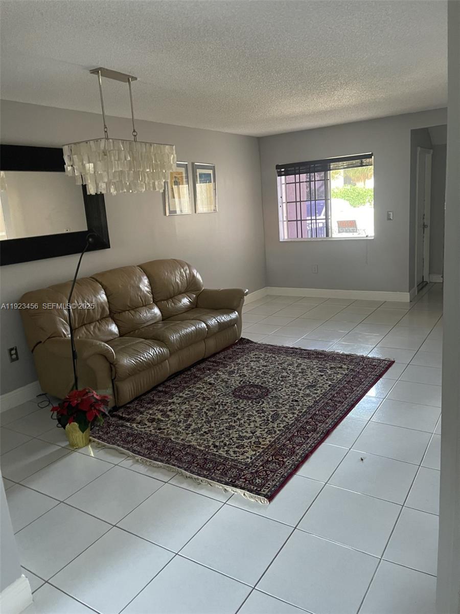 6606 Southwest 131st Path, Unit 1809A Miami, FL 33183 - Photo 3 of 14 a living room with couch and a window