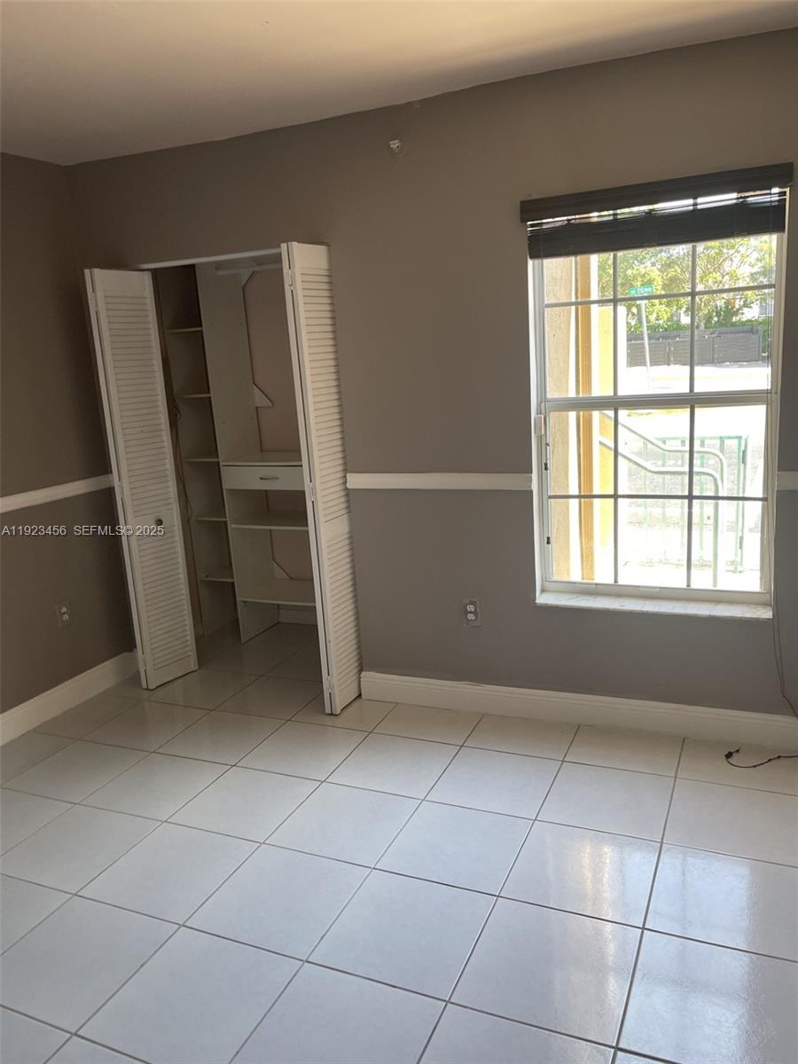 6606 Southwest 131st Path, Unit 1809A Miami, FL 33183 - Photo 6 of 14 a view of an empty room with a window