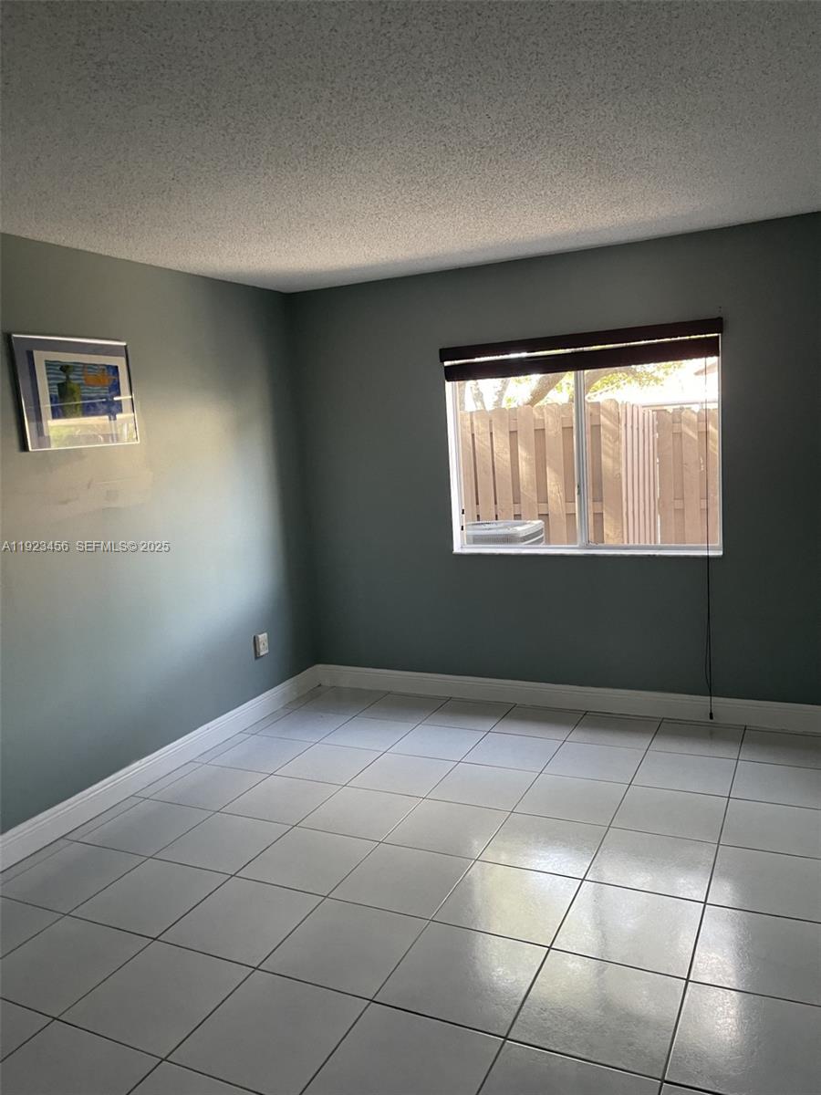 6606 Southwest 131st Path, Unit 1809A Miami, FL 33183 - Photo 8 of 14 an empty room with windows