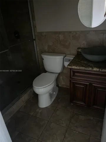 a bathroom with a toilet and a mirror