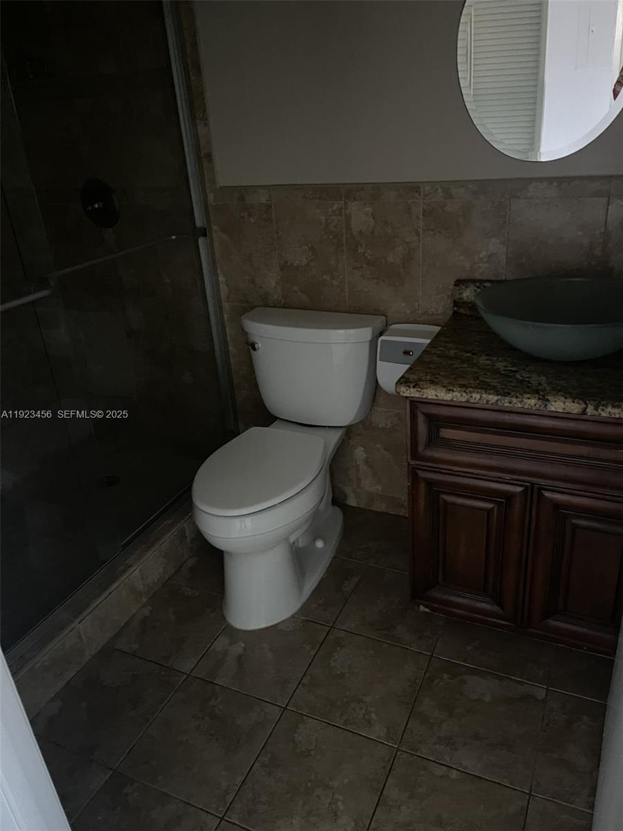 6606 Southwest 131st Path, Unit 1809A Miami, FL 33183 - Photo 10 of 14 a bathroom with a toilet and a mirror