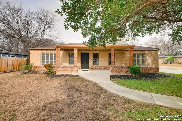 a house that has a tree in front of it