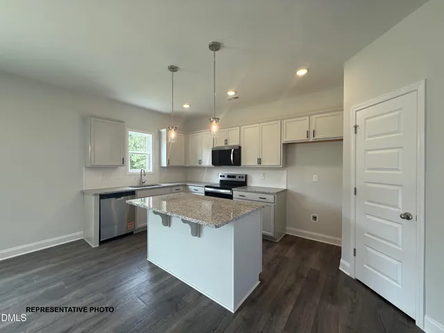 a kitchen with a stove a sink and a refrigerator