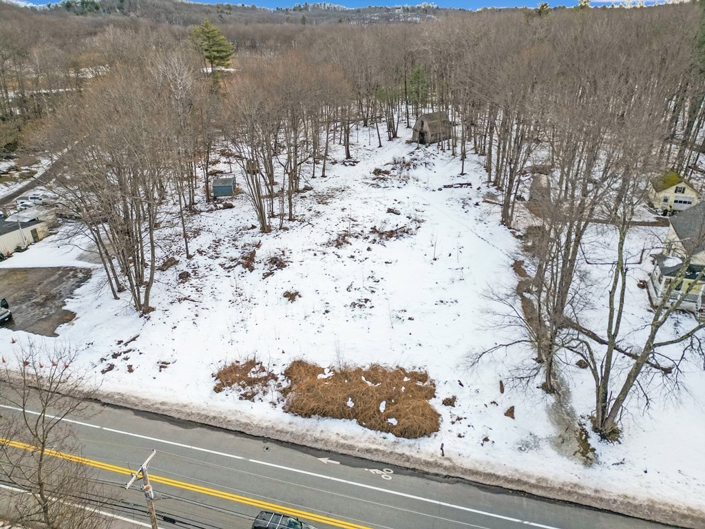 a view of white house with a snow and trees