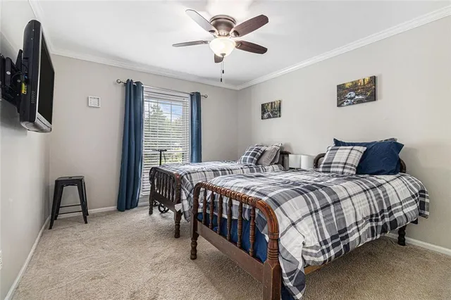 a bedroom with a bed a ceiling fan and a dresser