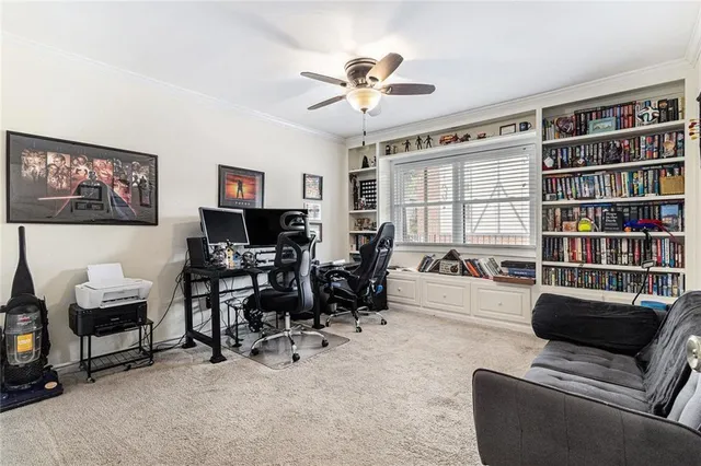 a living room with furniture and a bookshelf