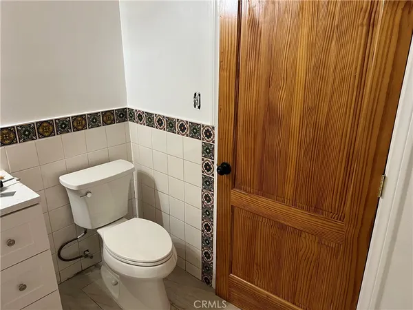 a white toilet sitting next to a sink