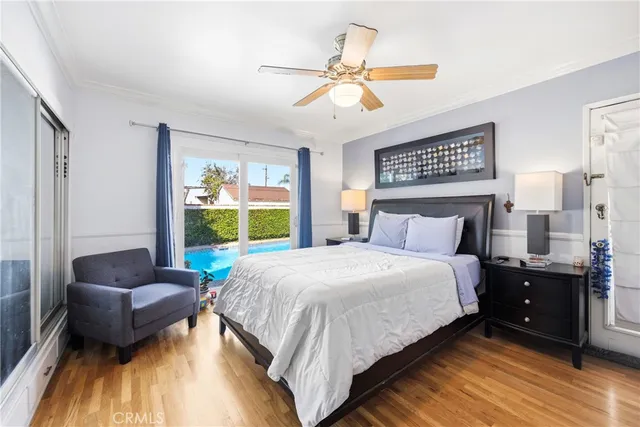 a bedroom with bed and wooden floor