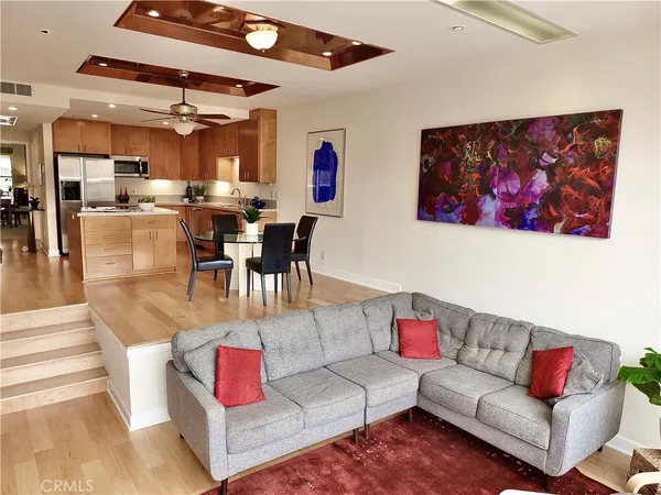 a living room with furniture and kitchen view