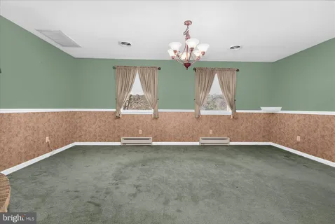 a view of empty room with a fireplace