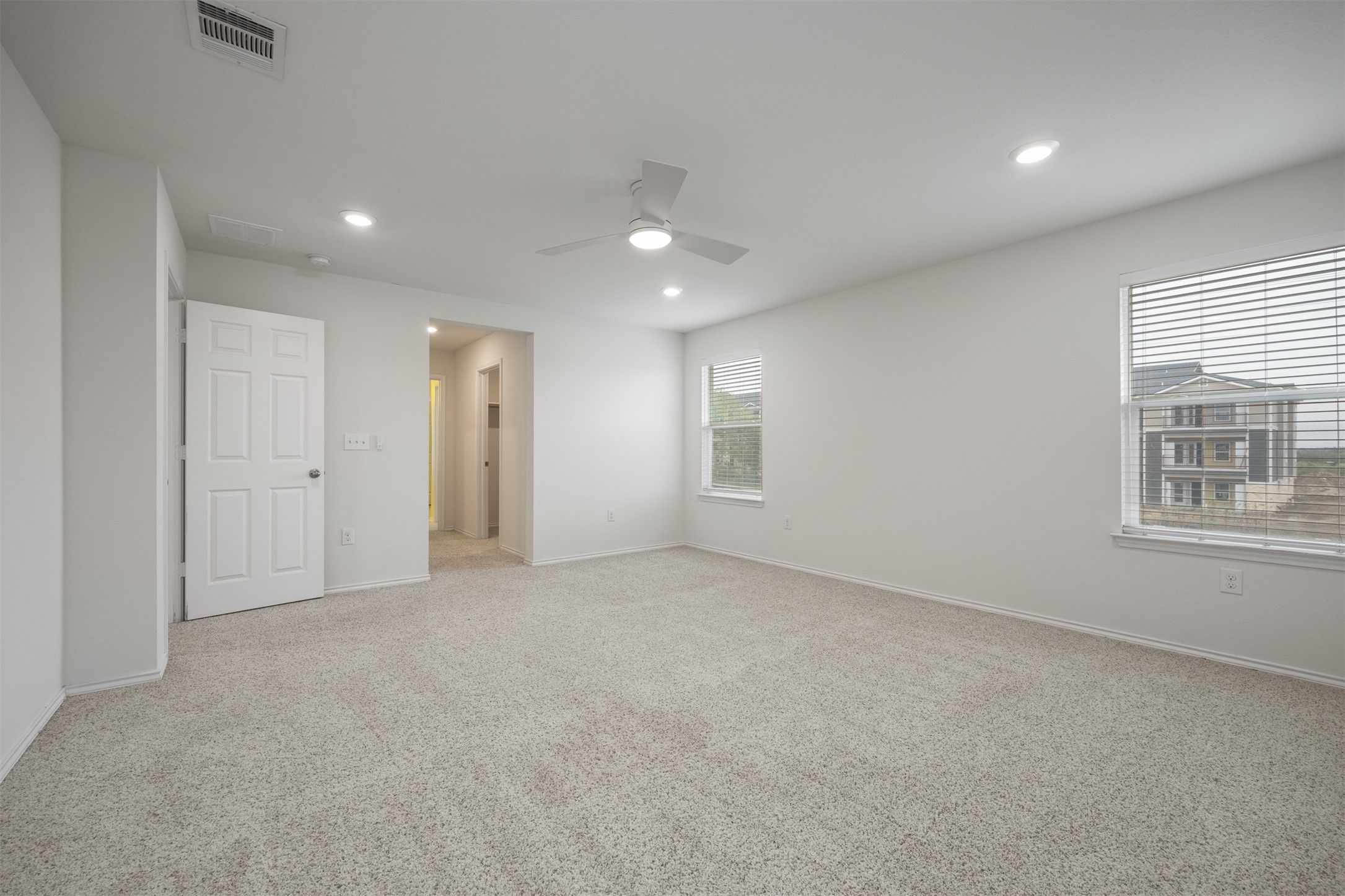 7009 Nutria Run Austin, TX 78744 - Photo 10 of 15 A well-lit, generous bedroom space offers comfort and ample natural light through multiple windows.