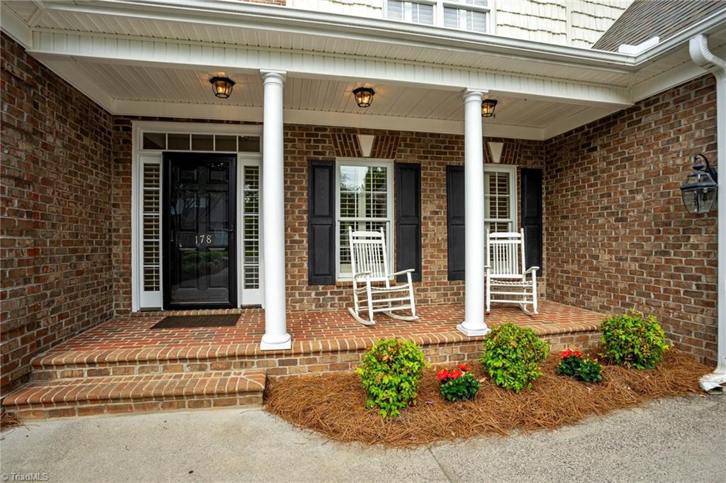 178 Sycamore Ridge Drive Bermuda Run, NC 27006 - Photo 3 of 45 Enjoy a conversation with friends on the rocking chair front porch.