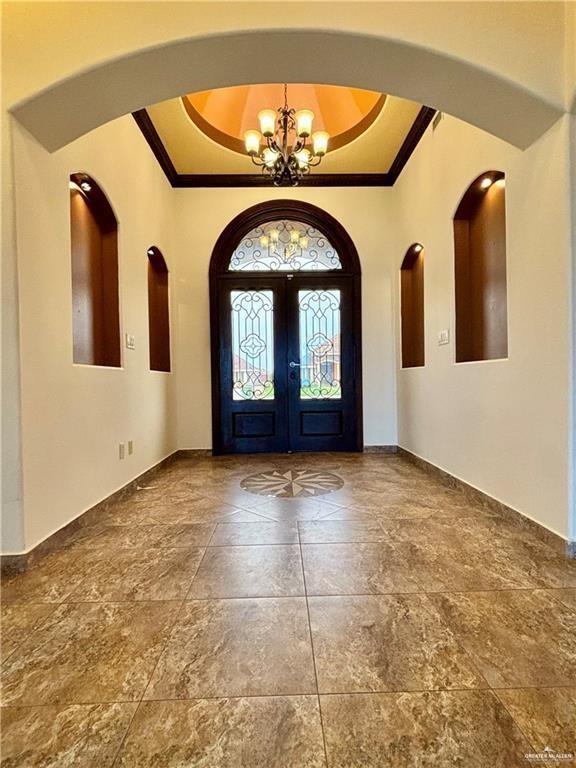 208 Thornwood Loop Rio Grande City, TX 78582 - Photo 19 of 21 a view of a big room with a chandelier and fireplace