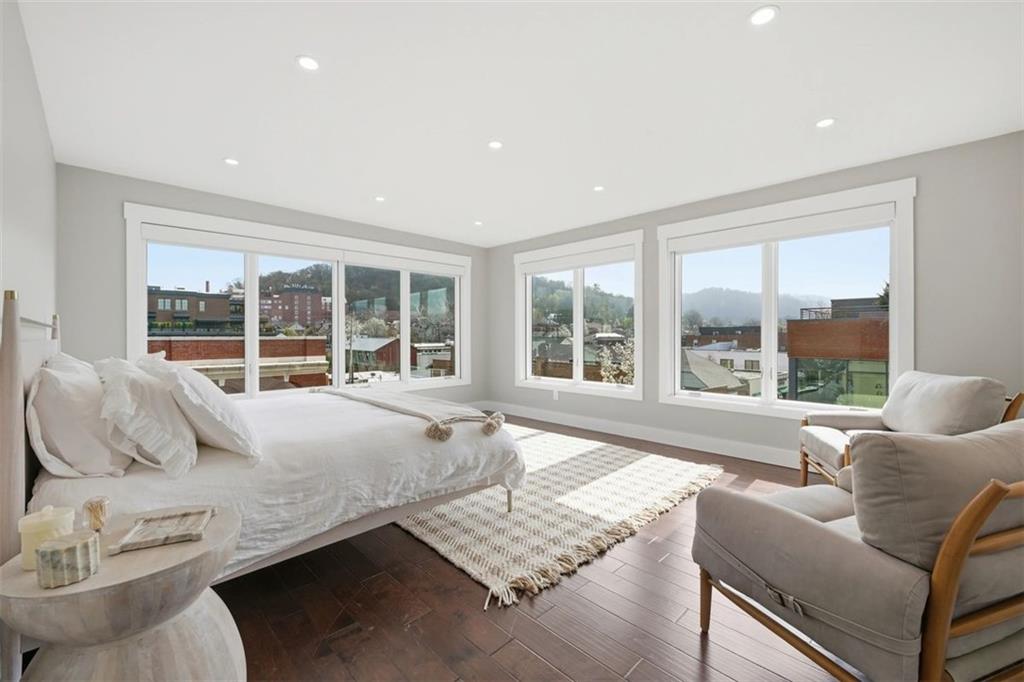 443 Walnut Street Sewickley, PA 15143 - Photo 26 of 50 The primary bedroom is serene and sunlit, wrapped in windows with views over the village rooftops. Enjoy Lutron motorized blackout blinds in all bedrooms.