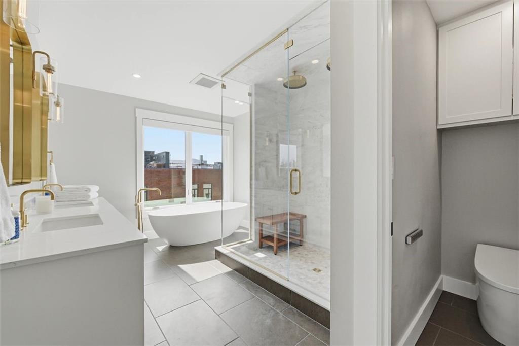 443 Walnut Street Sewickley, PA 15143 - Photo 30 of 50 The primary bath blends luxury and ease with a soaking tub, oversized shower, and refined brass details.