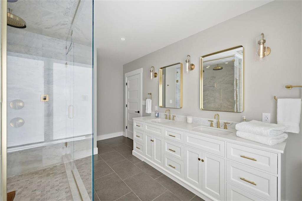 443 Walnut Street Sewickley, PA 15143 - Photo 32 of 50 Dual vanities and clean-lined cabinetry and hard wired backlit antifog mirrors give the primary bath both elegance and functionality.