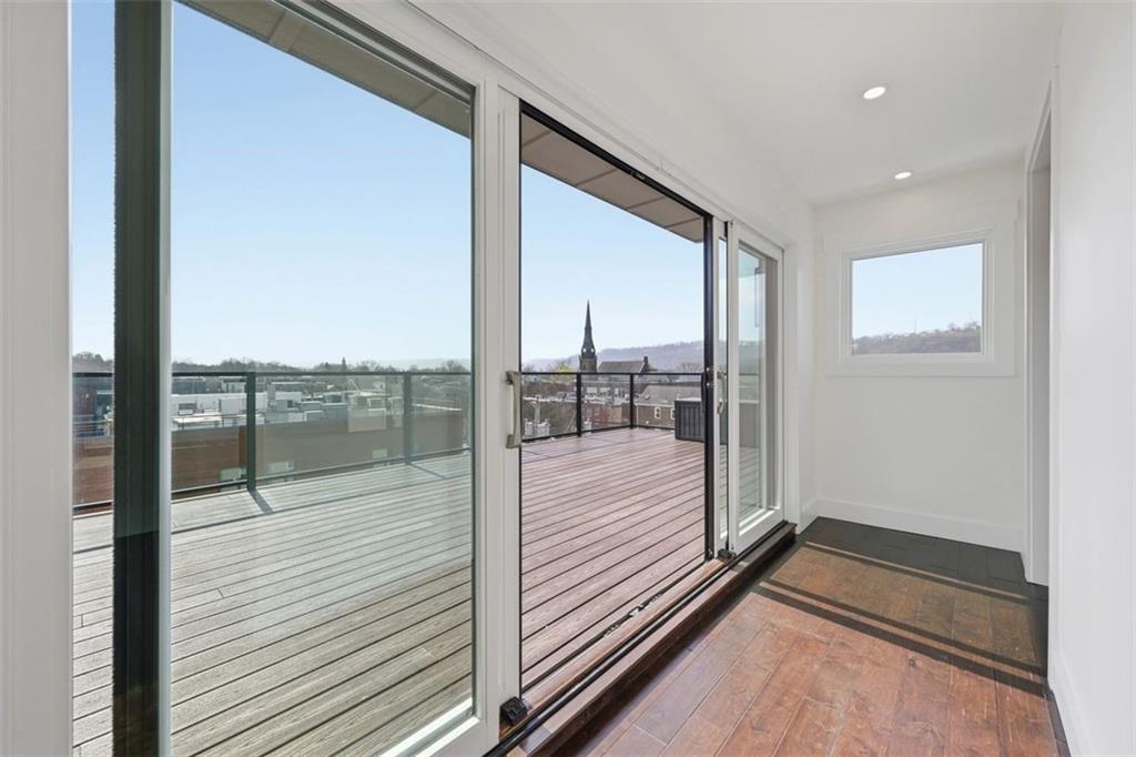 443 Walnut Street Sewickley, PA 15143 - Photo 40 of 50 Sliding doors create a seamless transition from inside to the rooftop terrace beyond. There is also a powder room on this floor adding to convenience for you and guests.
