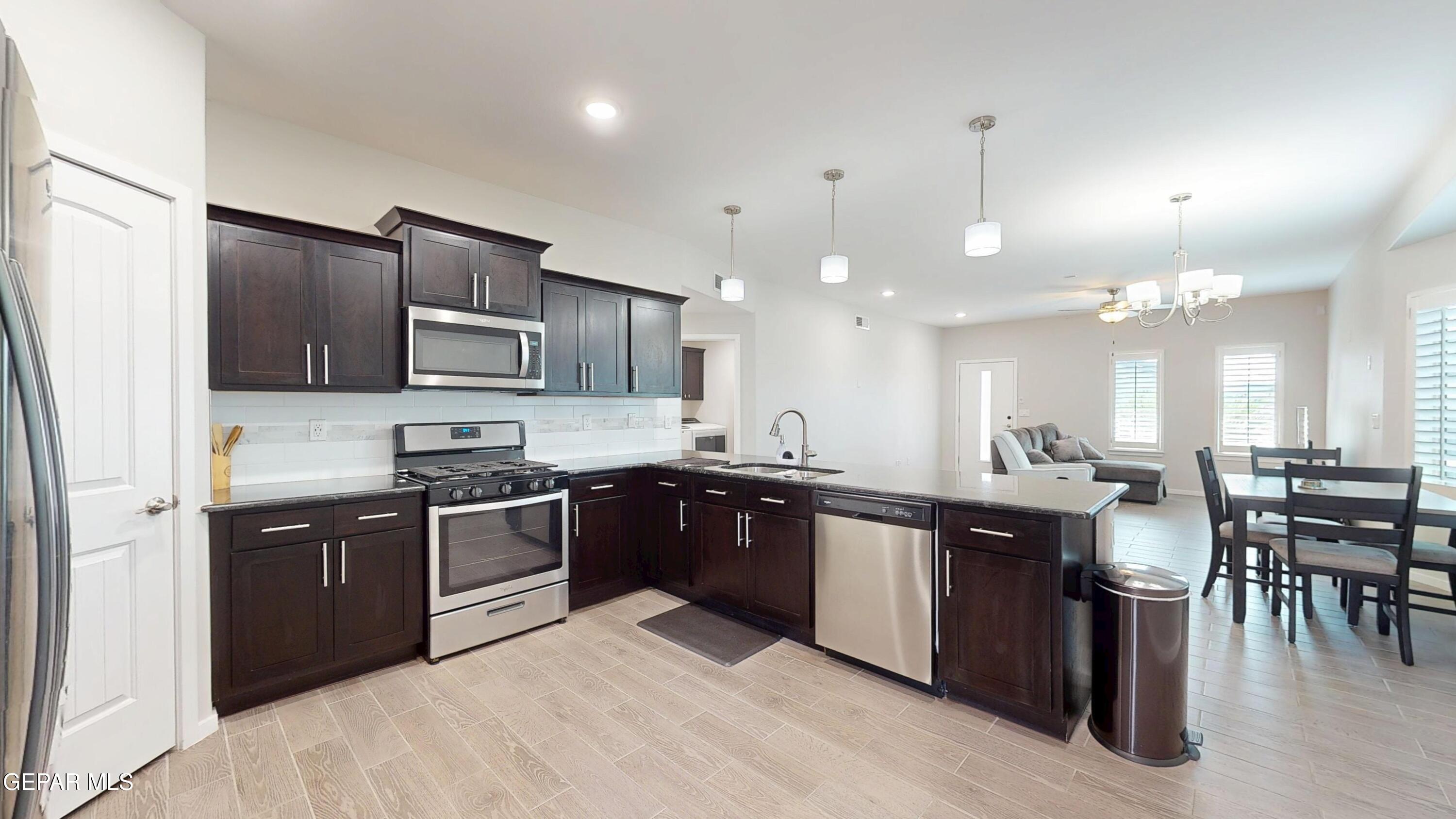 219 Notts Way El Paso, TX 79928 - Photo 11 of 35 a large kitchen with stainless steel appliances lots of counter space a sink and a refrigerator