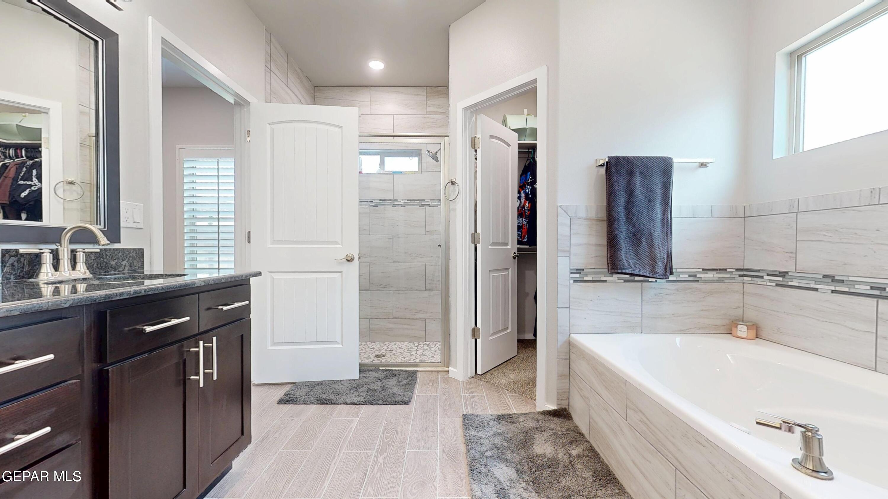 219 Notts Way El Paso, TX 79928 - Photo 19 of 35 a spacious bathroom with a tub sink shower and mirror