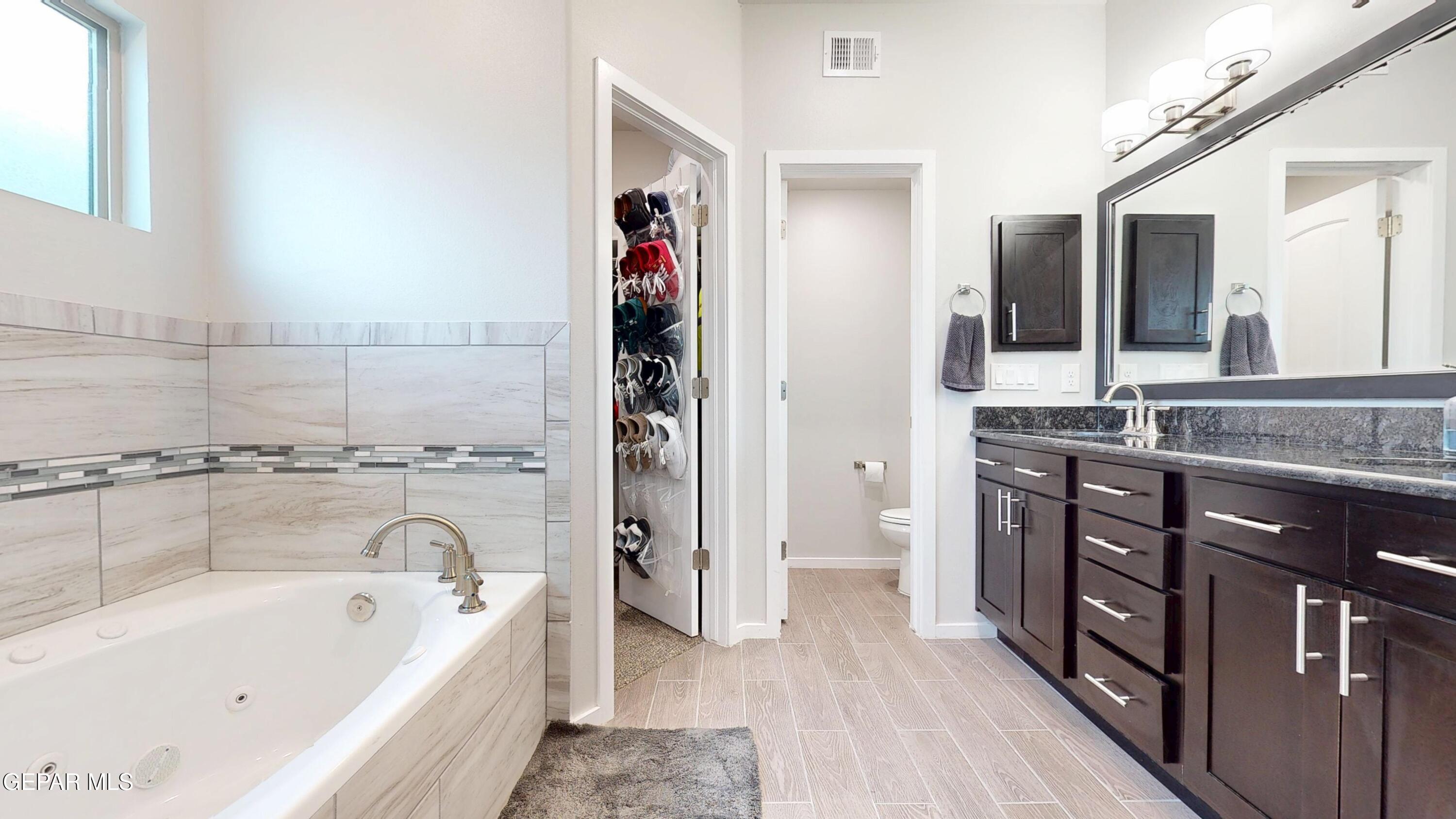 219 Notts Way El Paso, TX 79928 - Photo 20 of 35 a bathroom with a tub sink and mirror