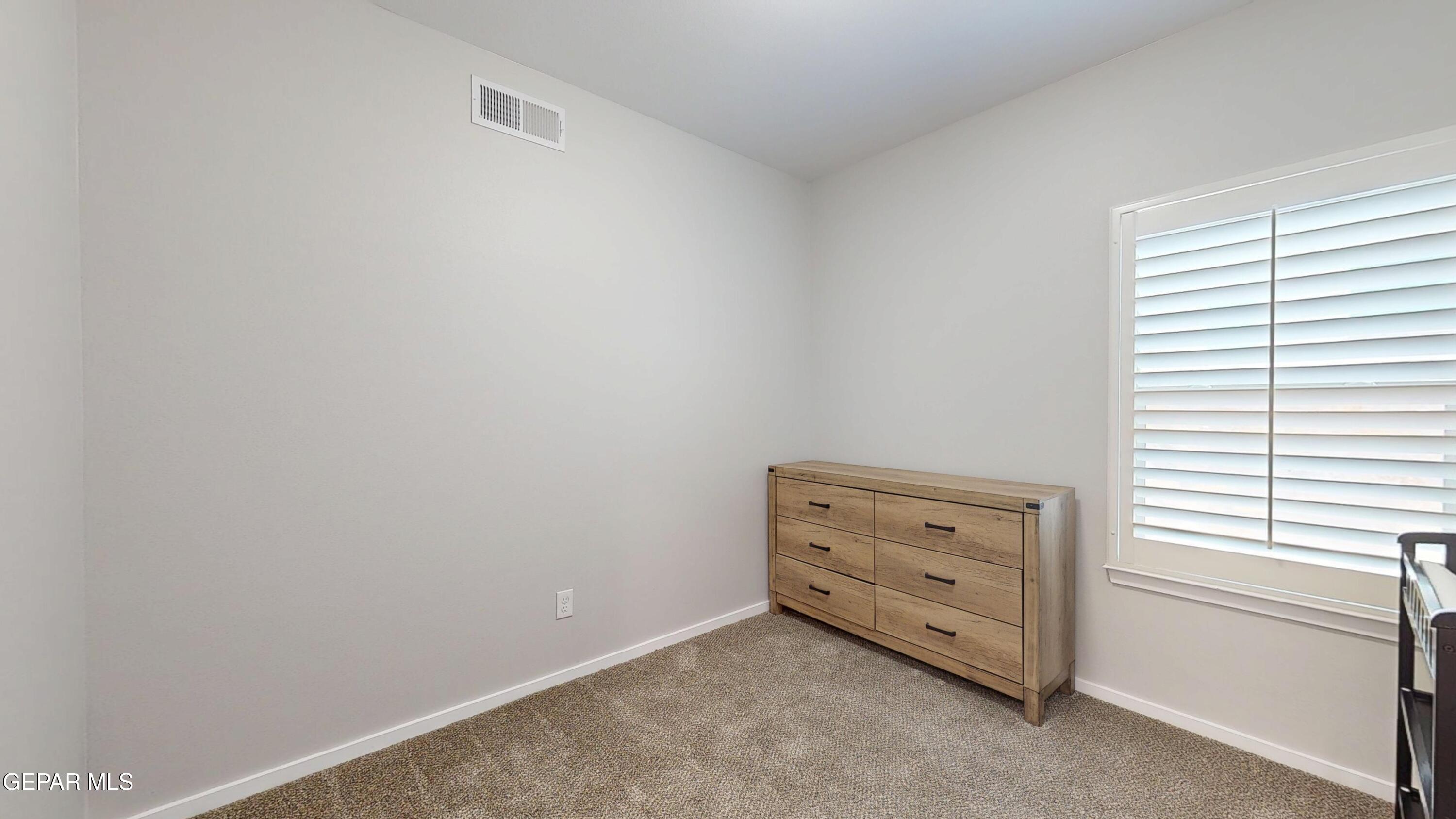 219 Notts Way El Paso, TX 79928 - Photo 28 of 35 a room with a baby crib and a window