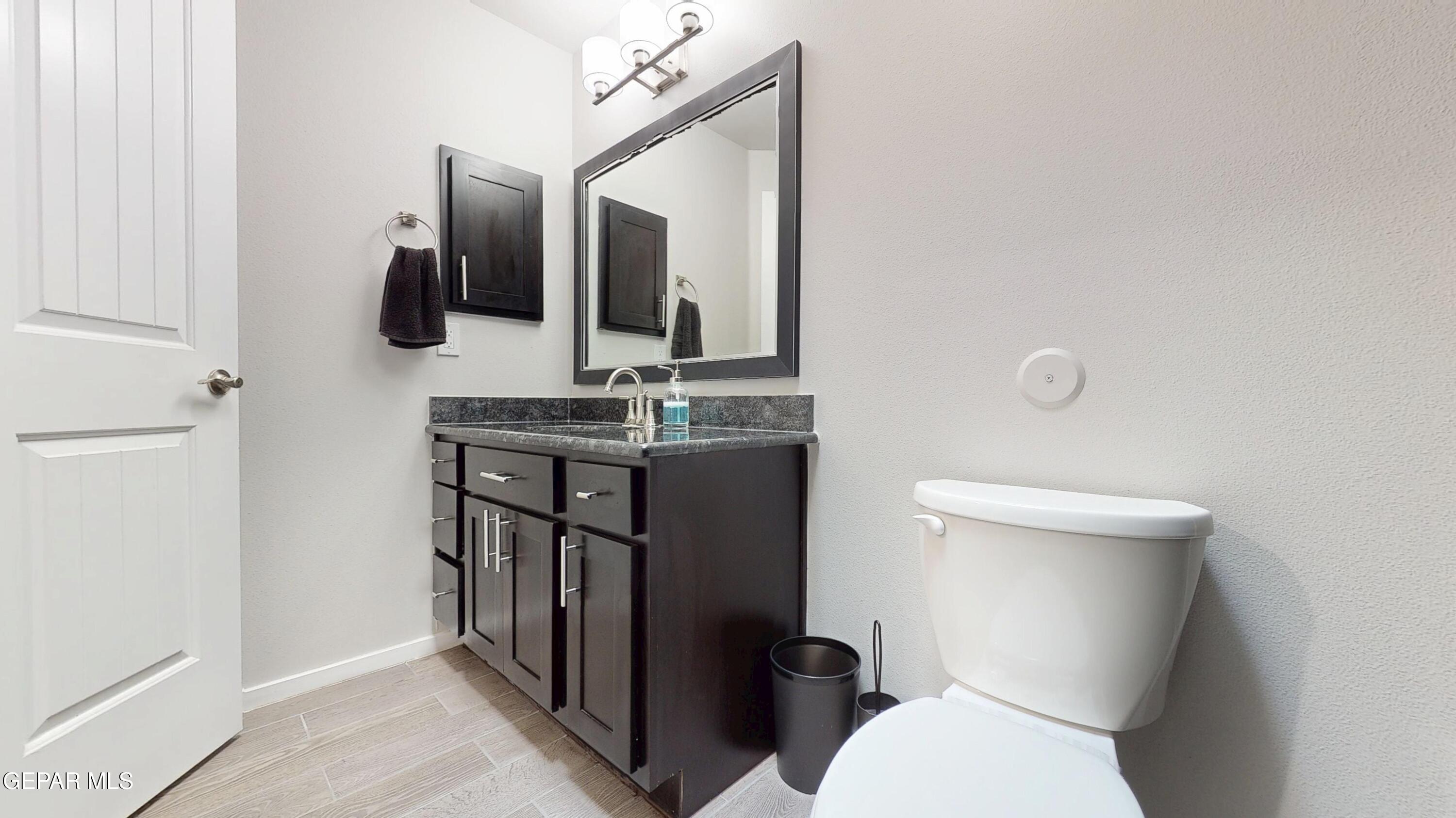 219 Notts Way El Paso, TX 79928 - Photo 33 of 35 a bathroom with a toilet sink and mirror