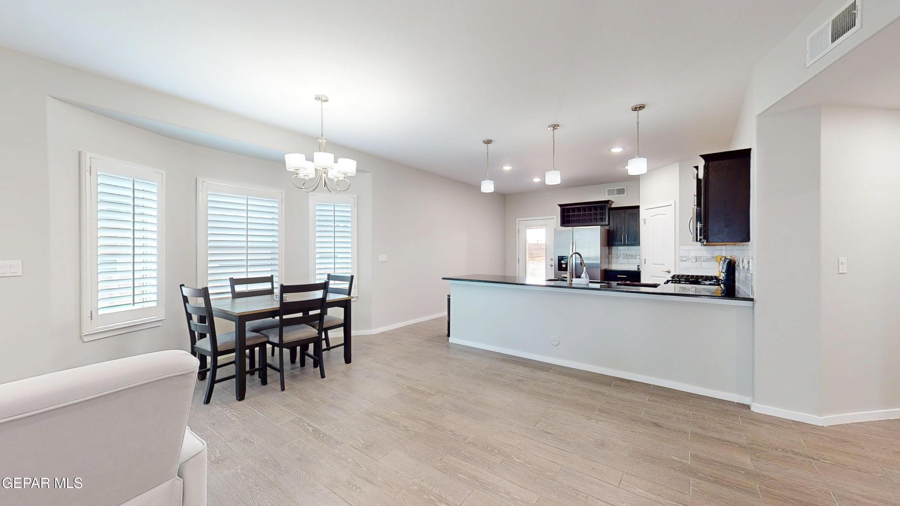 219 Notts Way El Paso, TX 79928 - Photo 6 of 35 a kitchen with a dining table chairs and microwave