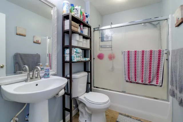 a bathroom with a sink toilet and shower
