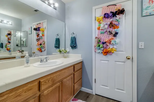 a bathroom with a sink a vanity and a mirror