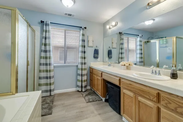 a spacious bathroom with a double vanity sink mirror and double