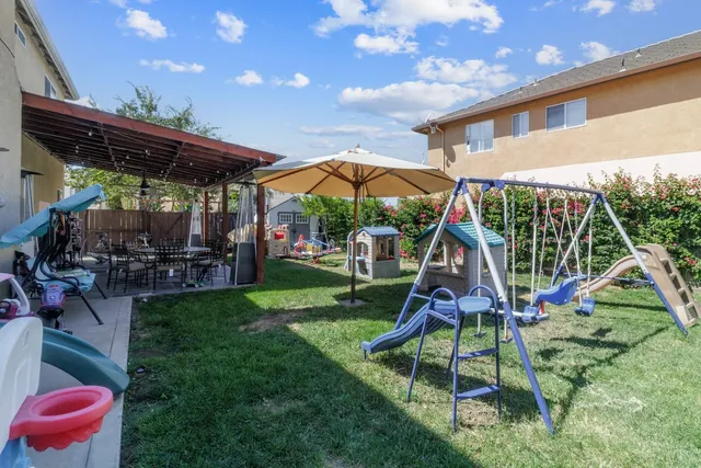 a view of backyard with a table and chairs