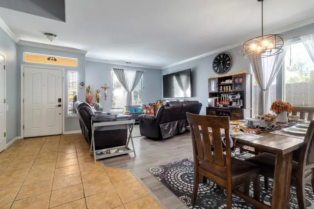 a living room with furniture a two dining table and a window