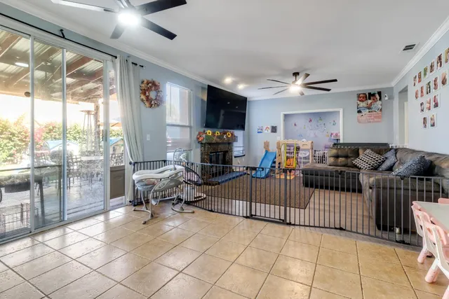 a living room with furniture a flat screen tv and a large window