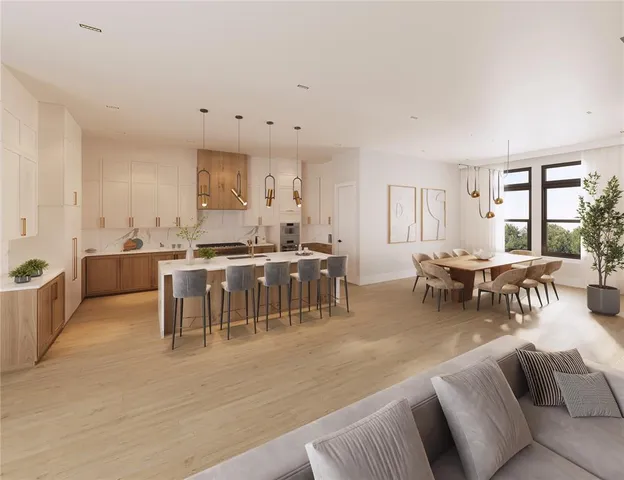 a living room with lots of furniture and kitchen view