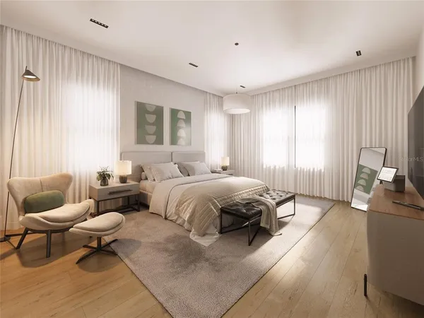 a spacious bedroom with a bed and chair