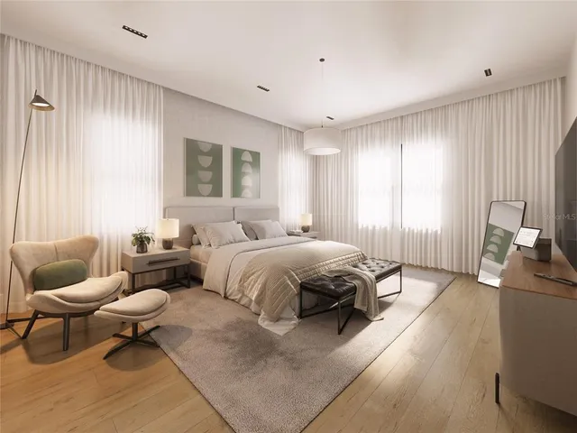 a spacious bedroom with a bed and chair