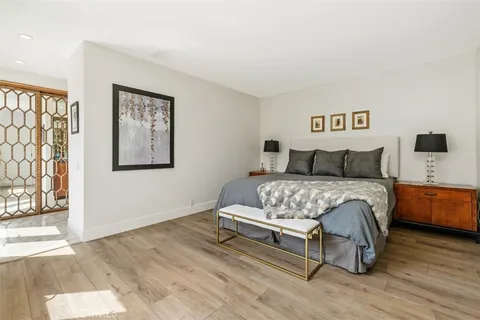 a bedroom with a bed and a night stand