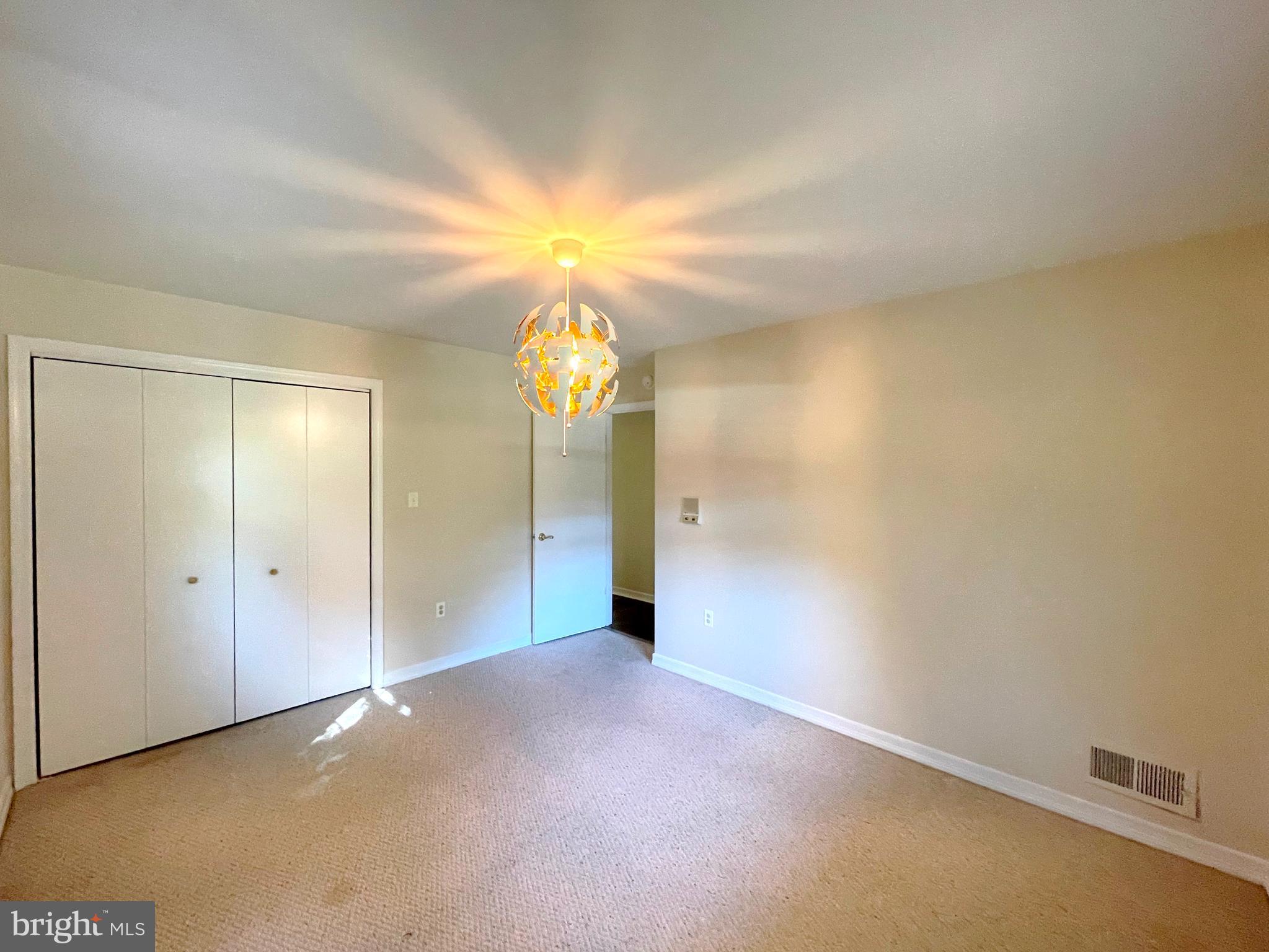 11717 Rivershore Drive Dunkirk, MD 20754 - Photo 22 of 49 an empty room with a chandelier fan and a chandelier fan