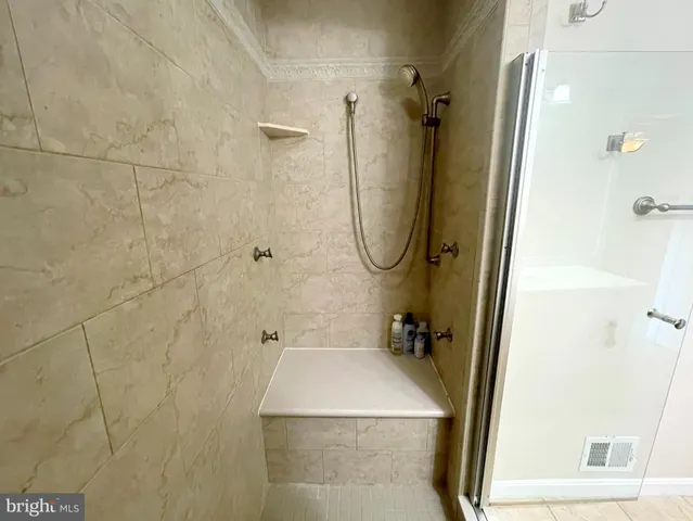 a bathroom with a sink a mirror and shower